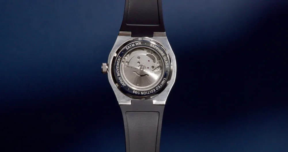 The caseback against a deep blue backdrop.