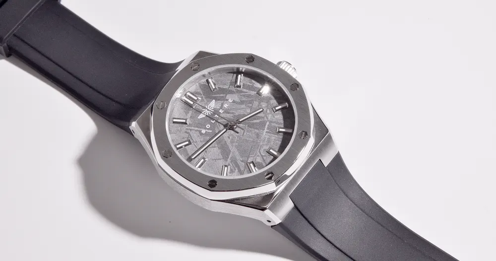 The dial at a low angle on a white surface.