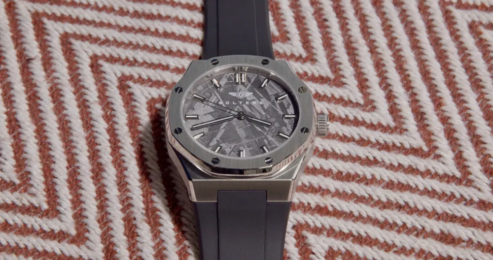 Close on the dial over a herringbone weave.
