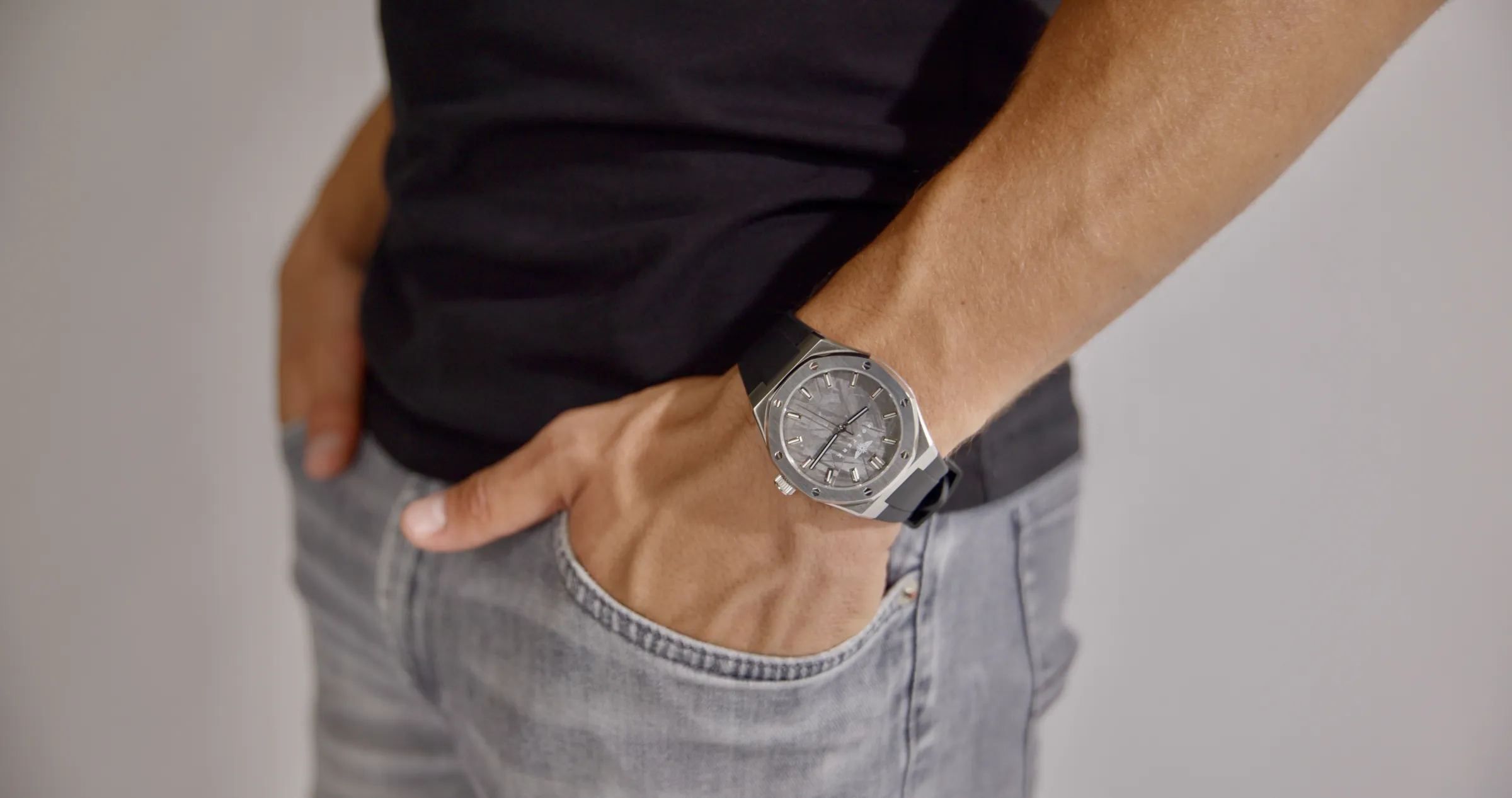 The Visto on a wrist, hand in the pocket of grey jeans.